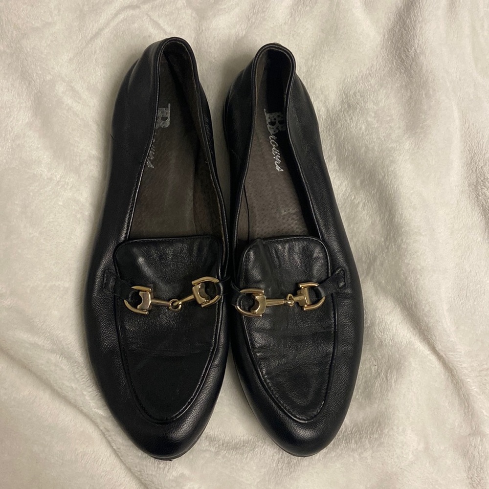 Black loafers from gold detailing